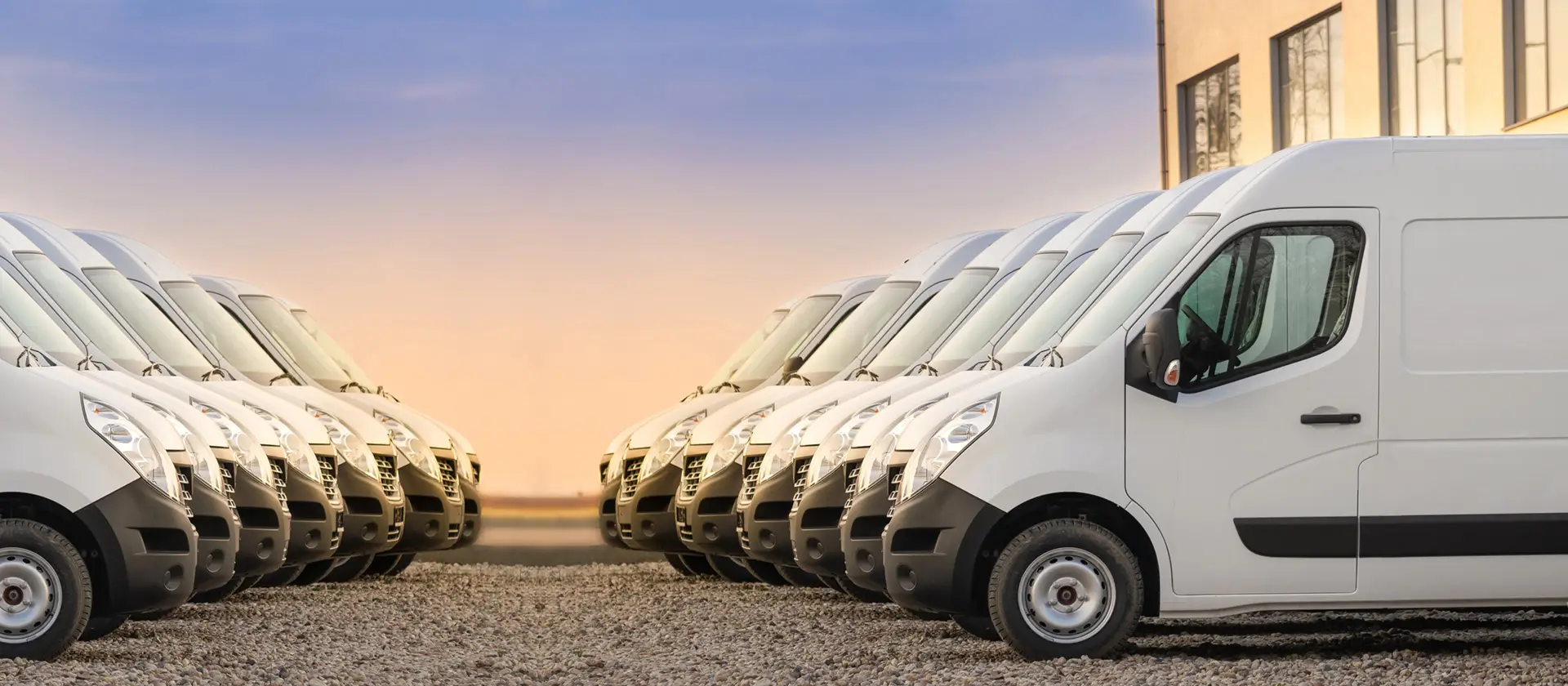 Fleet vehicles parked with a sunset background